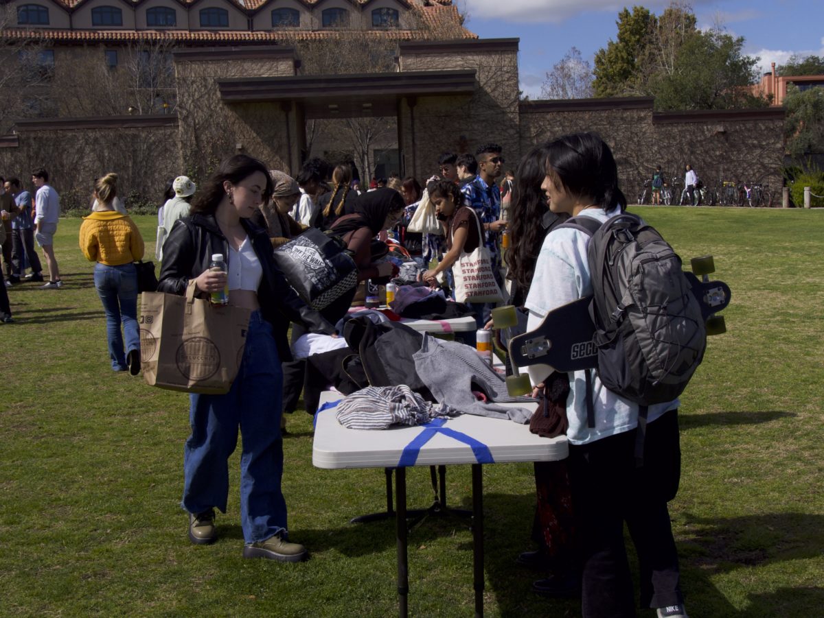 Students look at tables of clothes.