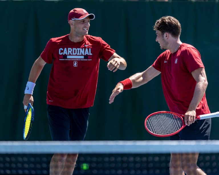 Axel Geller and Tomas Kopczynski high five during a match.