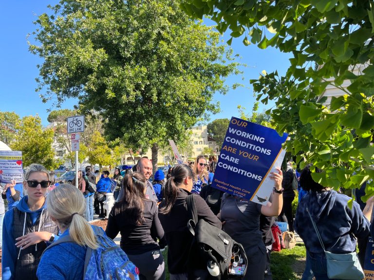 Nurses holding signs protest outside Stanford hospital