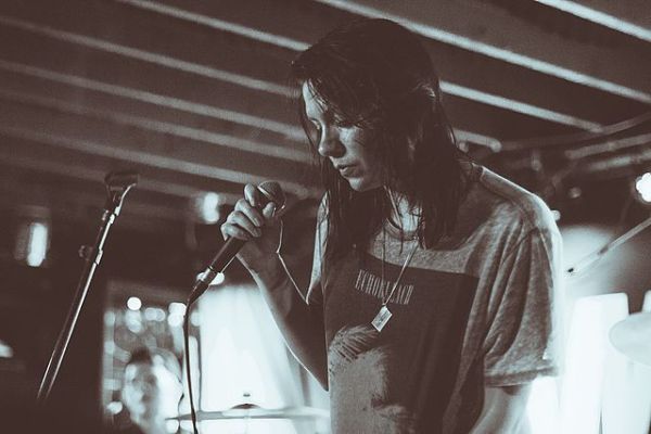 K.Flay singing in black and white.