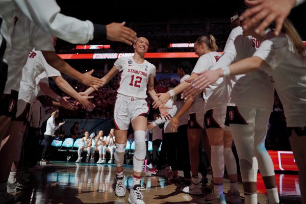 Lexie Hull high fives her teammates as she runs out onto the court.