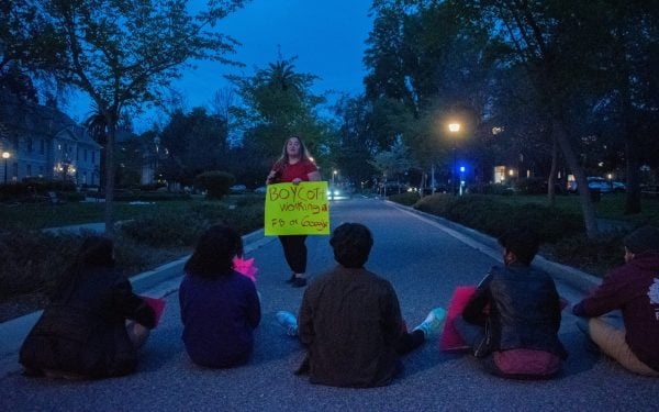 Student activists lined up on Mayfield avenue with colorful signs displaying messages of protest.