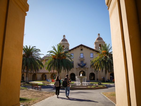 two people walking towards fountain in old union