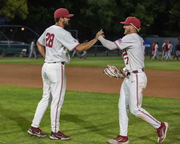 Senior pitcher Alex Williams and junior outfielder Brock Jones high five