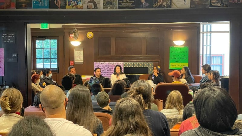 A group of students sit iin a room in the Kairos House at a teach-in with the Chairwoman of the Muwekma Ohlone Tribe of the San Francisco Bay Area. 