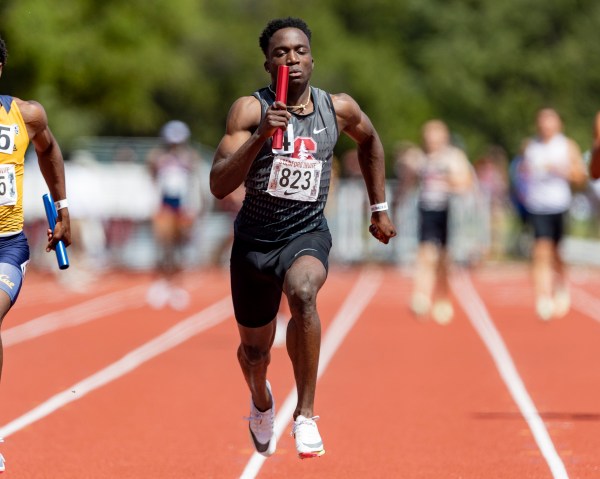 Udodi Onwuzurike sprints toward the finish line during a relay race.