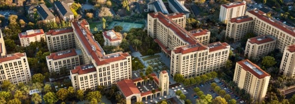 The EVGR housing complex, featuring several multistory apartment buildings, greenery, and tennis courts