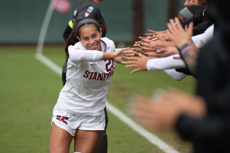 Samantha Williams smiles as she high-fives fans