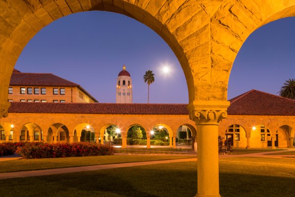 The Center for Comparative Studies in Race and Ethnicity (CCSRE), housed in Building 360. Arches and Hoover Tower visible at dusk.