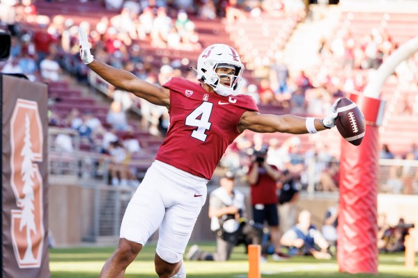 A football player celebrates with his arms in the air