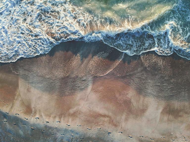 Ocean waves crash on a beach.