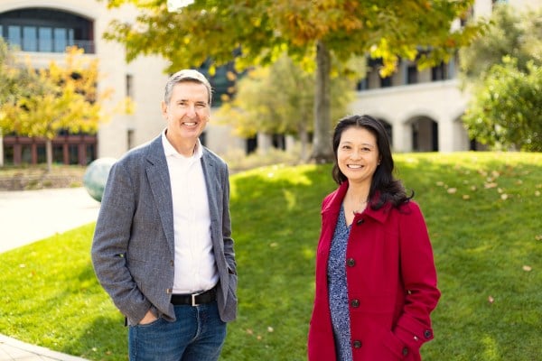 Tom Byers and Mo Fong stand in front of a grass