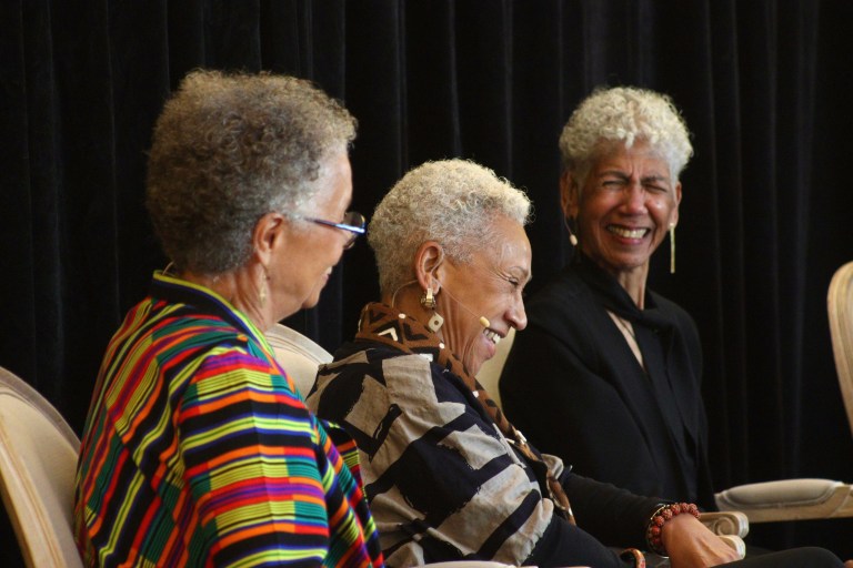 Rosita Thomas, M. Gayle Asali Dickson, and Ericka Huggins smile and laugh