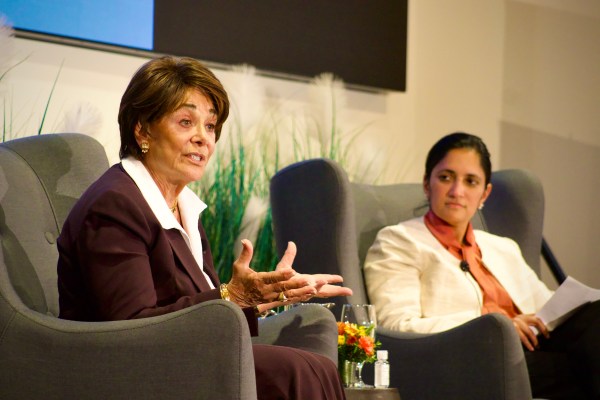 Anna Eshoo sits in a chair next to a moderator on the stage