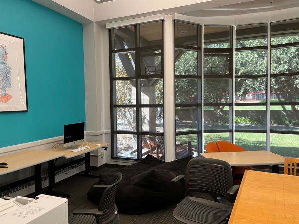 Inside of Lantana's computer cluster. The room is filled with various chairs and tables and the back wall is made up of window panes.