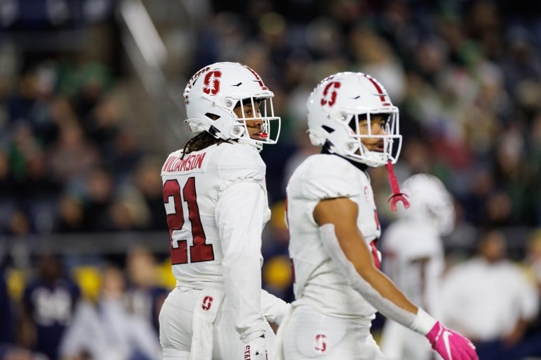 Two football players stand side by side