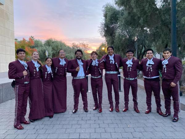 The Mariachi Cardenal, dressed in traditional costume, line up to pose in a picture