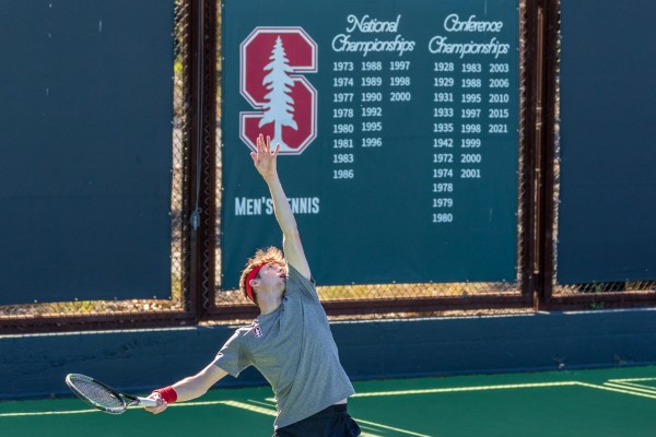 Max Basing tosses the ball up to serve.