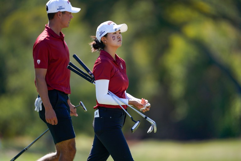 Two golfers walking next to each other