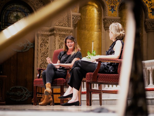 Lulu Miller sits on the left, behind Prof. Caroline Winterer on the right.