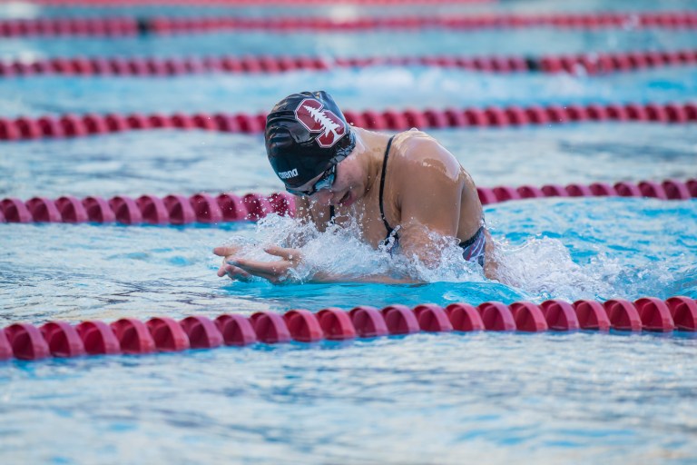 A swimmer emerges from the water