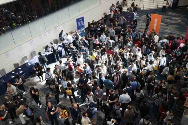 a crowded, indoor career fair with various booths