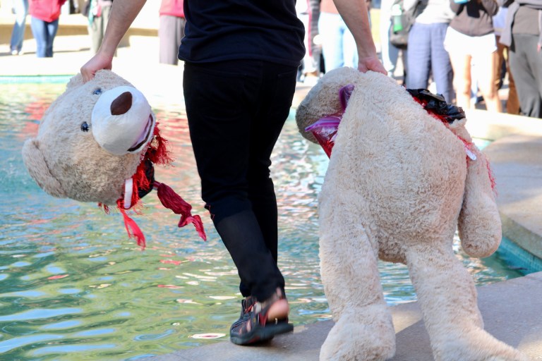 The 2022 Bearial, where a student has the head and body of a bear in separate hands and walks into The Claw, a fountain.