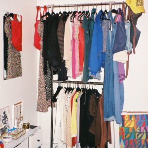 Two-tier clothing rack filled with clothes