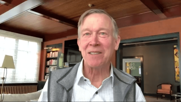 Hickenlooper smiles wearing a vest