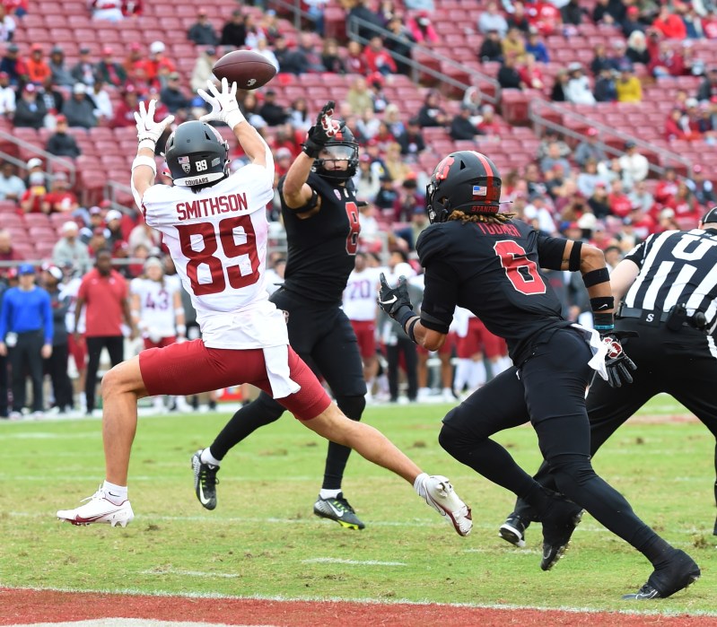 A football player leaps to catch a football