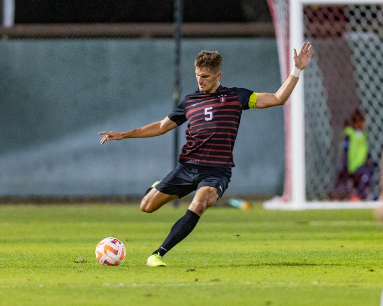 A soccer player kicks a ball