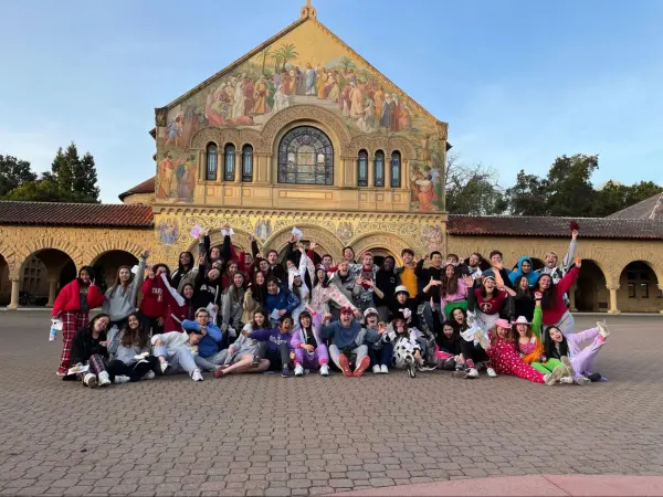 Many tour guides posing for a photo outside of MemChu.