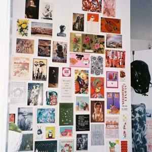 Postcards on a wall.