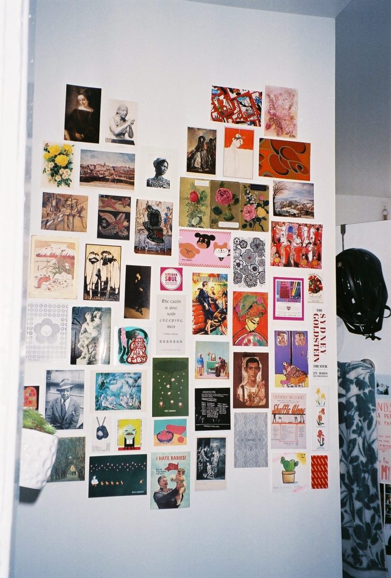 Postcards on a wall.