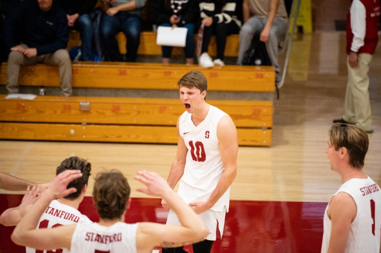 A volleyball player shouts in celebration