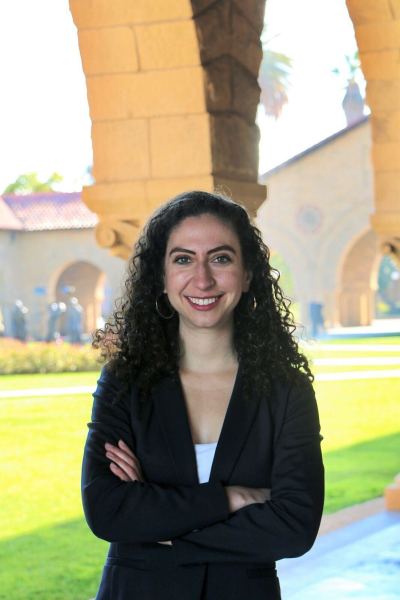 Kyra Jasper stands in front of an arch in Main Quad