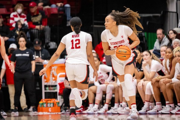 A basketball player holds the basketball and looks to pass