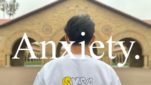 A person faces main quad, with the word 'Anxiety" overlaying the photo.