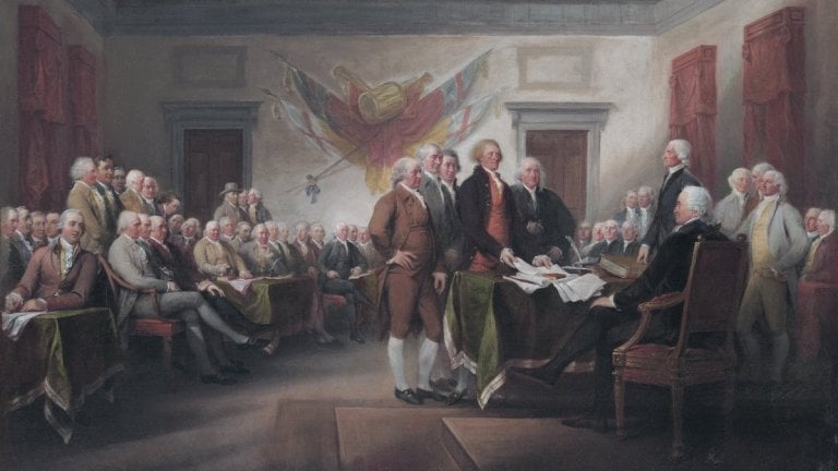 men dressed in 18th-century style stand around a document