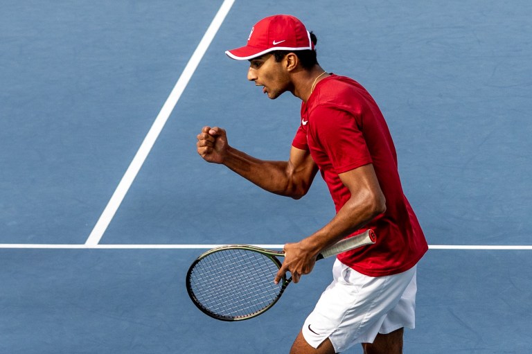 Samir Banerjee fist pumps in celebration on the court.