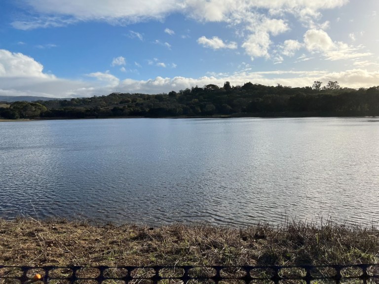 Lake Lag glimmers in the sunlight, completely full with water.