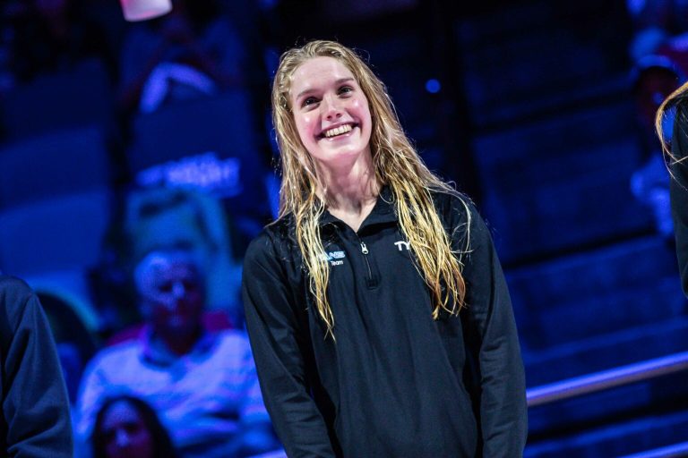 Claire Curzan pictured smiling during an awards ceremony.