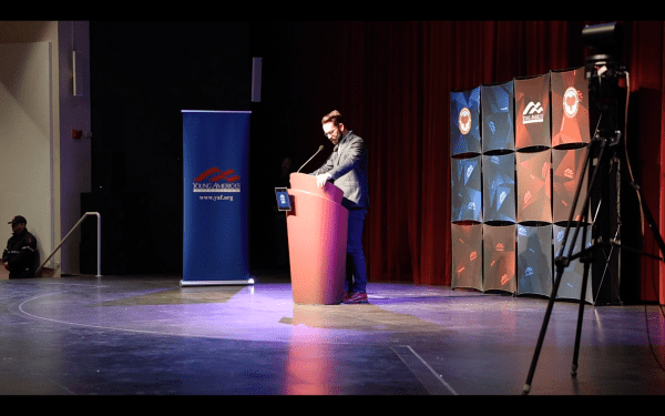 A person stands at a podium in the late.