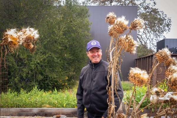 Conrad Schmidt stands in a garden on campus