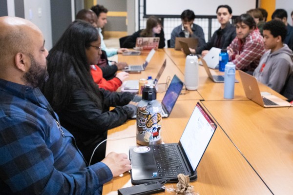 Table view with UGS members with laptops open.