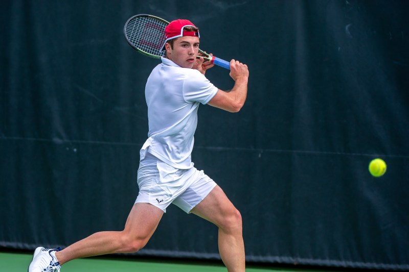 A man hitting a tennis ball