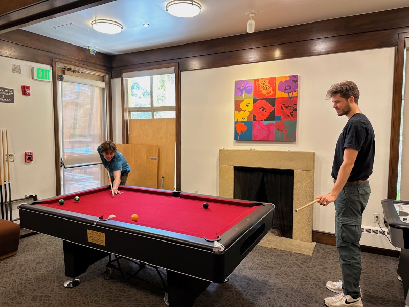 Two students playing pool