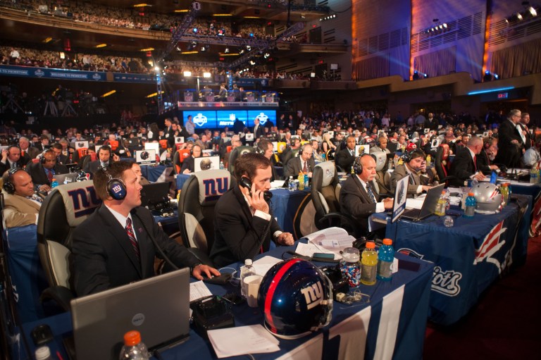 NFL team personnel communicate via phone during the 2012 NFL Draft.