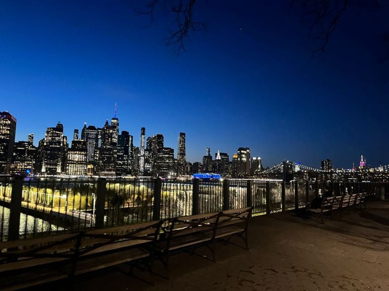 pedestrian walkway offering views of tall buildings in the city