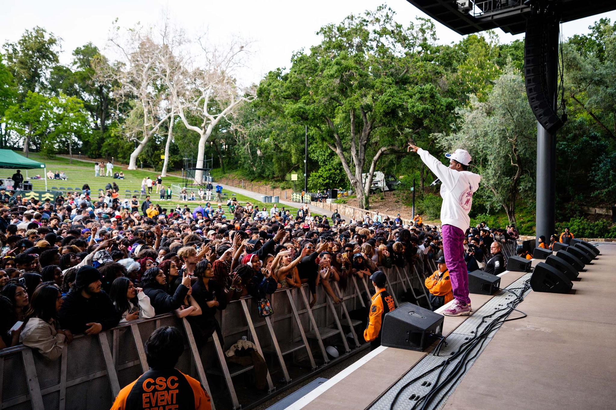 Pi'erre Bourne is on-stage performing to a large crowd at Frost Amphitheater.